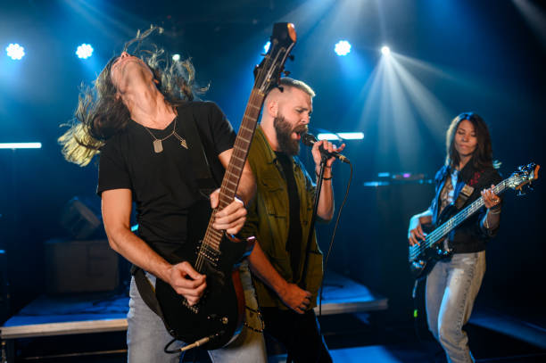 istock Rock band performing energetically on stage with passionate musicians 2185015744