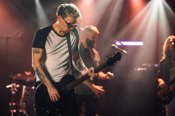 istock Guitarist performing live on stage with band 2185015759