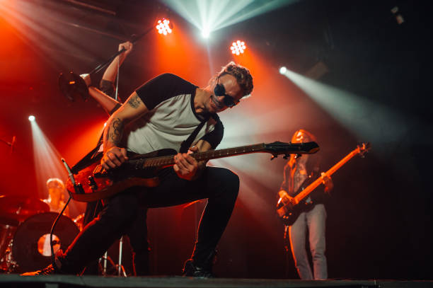 istock Guitarist performing energetically on stage during concert 2185015764