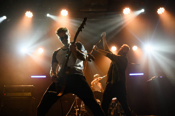 istock Guitarist and singer performing with passion on stage 2185015774