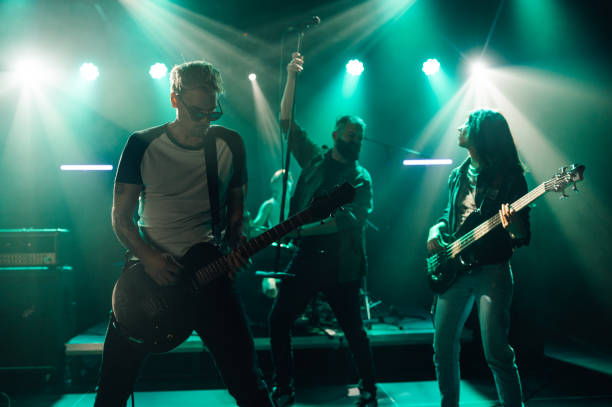 istock Rock band performing live on stage with energetic musicians 2185015775