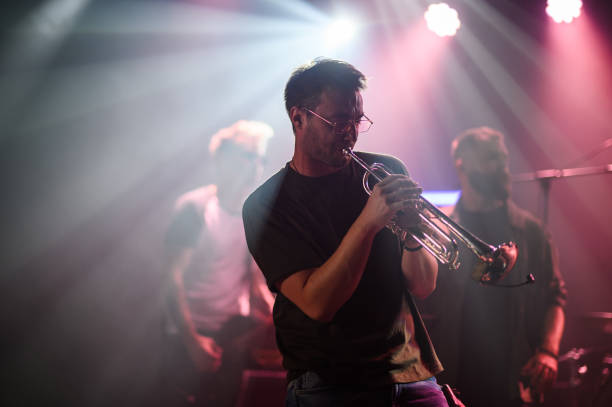 istock Trumpet player performing live on stage with band 2185015787