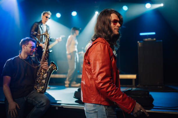 Music band performing live on stage with lights and instruments