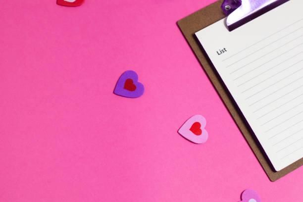 istock Women's pink office desk. Notepad, pen, stickers on a pink background. Flat lay, top view, copy space, banner 2185017407