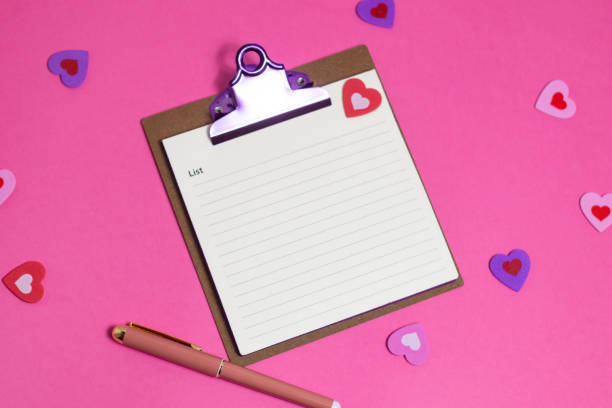 istock Women's pink office desk. Notepad, pen, stickers on a pink background. Flat lay, top view, copy space, banner 2185017464