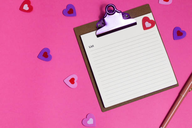 istock Women's pink office desk. Notepad, pen, stickers on a pink background. Flat lay, top view, copy space, banner 2185017487