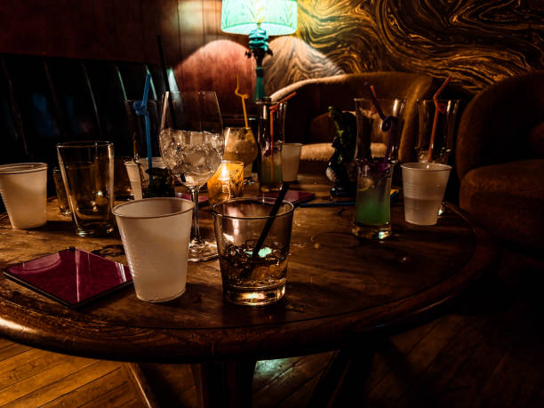 istock Scattered glasses and empty drinks on a bar table after a party 2185019528