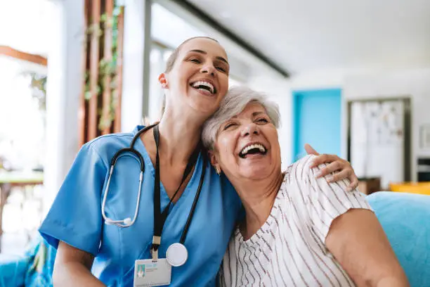 Home care healthcare professional hugging senior patient Home care healthcare professional hugging senior patient