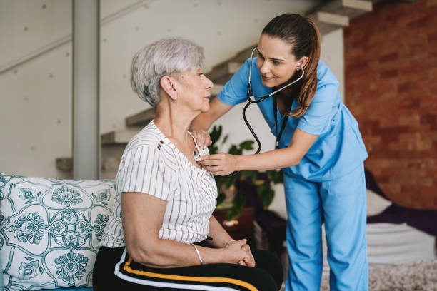 istock Home care healthcare professional using stethoscope 2185020327