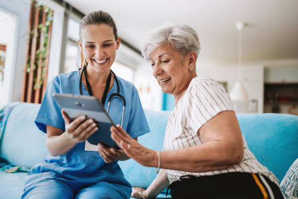 istock Home care healthcare professional using digital tablet 2185020338