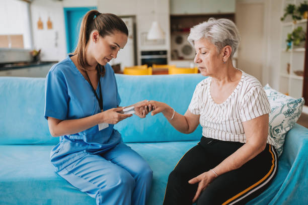istock Home care healthcare professional using oximeter 2185020352