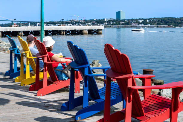 istock Adirondack chairs with people looking to the harbour 2185022133