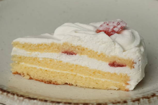 istock One small Japanese strawberry shortcake on a stylish large plate on a white table 2185023086