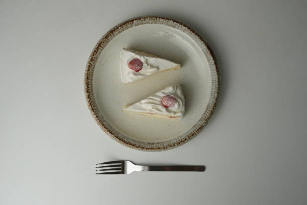 istock Two Japanese strawberry shortcakes and a large fork on a stylish large plate on a white table 2185023298