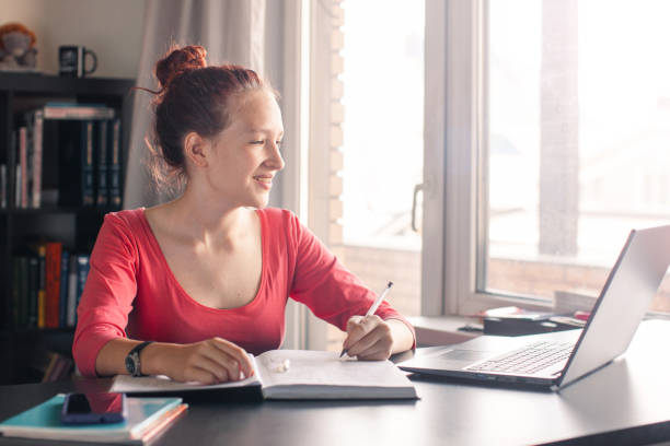 istock Millennial student sit at desk study on laptop 2185035141