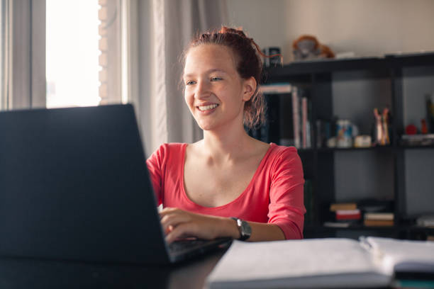 istock Female student looking at laptop screen at home 2185035149