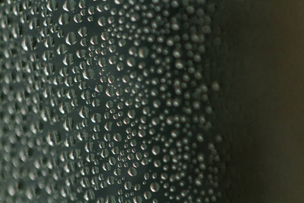 istock Raindrops texture. Drops on glass during rainy, wet, damp weather 2185035695