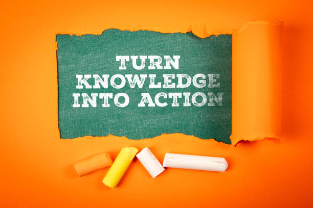 istock Turn knowledge into action. Text under torn orange paper on a green chalkboard 2185036090
