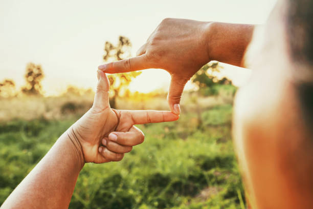 istock close up woman make hand framing gesture distant view. business concept 2185036975