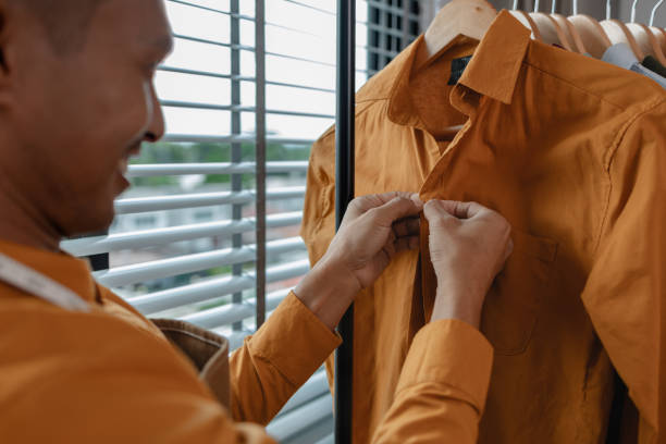 istock a designer is working in his studio, checking all clothes before sent to shop, talented designer is happy with his work, stylish. fabric, sewing, fashionable, entrepreneur 2185040068