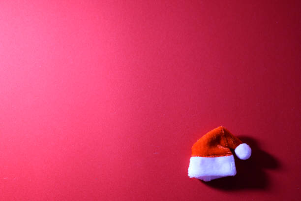 istock Santa Claus hat on red background. 2185040084