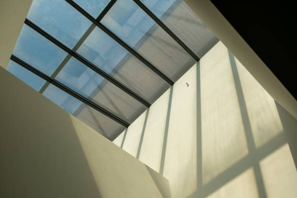istock Abstract, minimalist, modern architectural space with concrete walls and opening skylight 2185045666