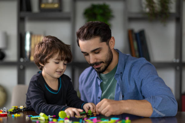 istock Father and son playing with intelligence development toys together as a leisure activity 2185049095