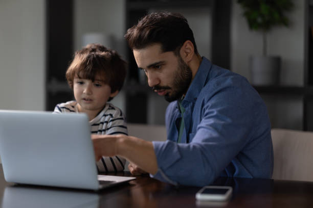 istock Father and little son playing games with Laptop in leisure activity 2185049192