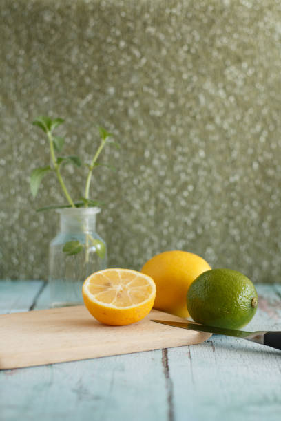 istock fresh lemons and lime on a cutting board 2185051751