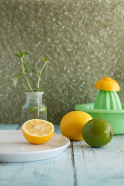 istock fresh lemons and lime on a white plate 2185051753