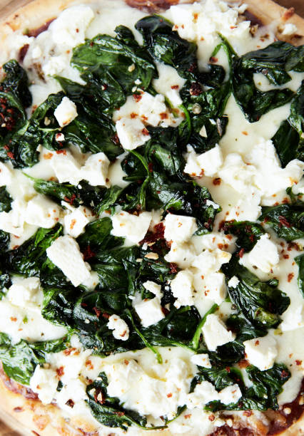 istock Pizza with mozzarella cheese and spinach. Dark wooden background. Close up. 2185053951