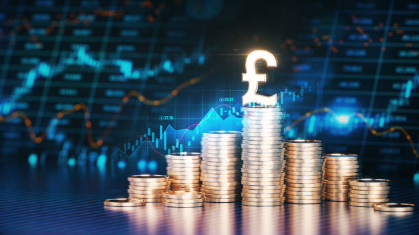 The Pound Symbol on Top of Stacks of Coins in Front Of a Financial Chart in the Background The Pound Symbol on Top of Stacks of Coins in Front Of a Financial Chart in the Background. Business and Finance concept. british currency stock pictures, royalty-free photos & images