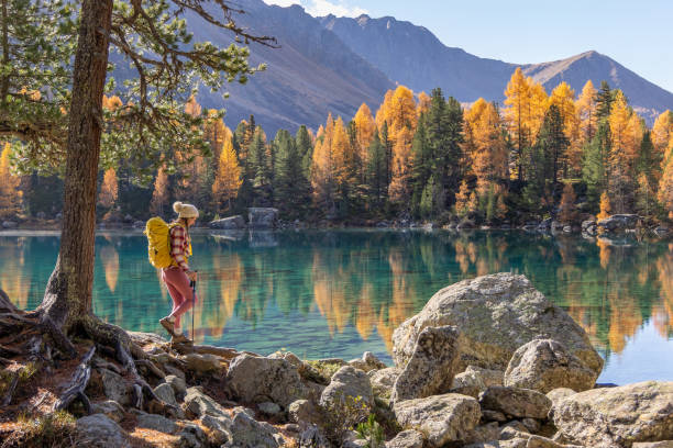 istock A man hiking by a pristine alpine lake in autumn 2185054272