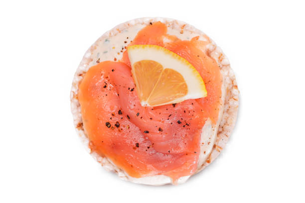 istock Rice Cake Sandwich with Fresh Salmon and Lemon - Isolated on White 2185055612