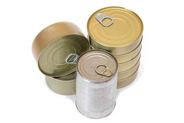 A Group of Stacked Tin Cans with Blank Edges Isolated on White Background. Canned Food. Different Aluminum Cans for Safe and Long Term Storage of Food. Steel Sealed Food Storage Containers - Isolation