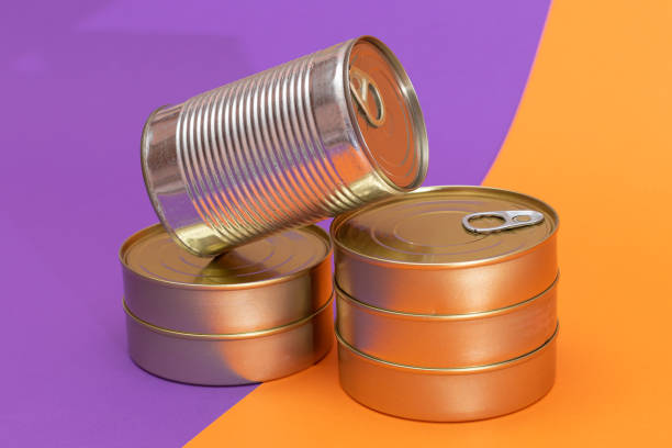 istock A Group of Stacked Tin Cans with Blank Edges on Split Orange and Violet Background 2185055922