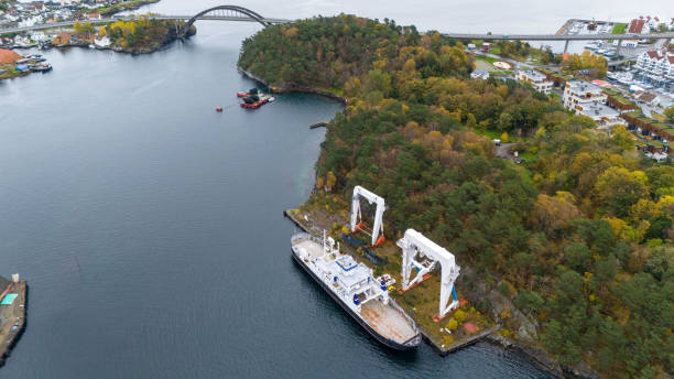 istock Aerial View of Ship Docked at an abandoned Shipyard with Cranes 2185056511