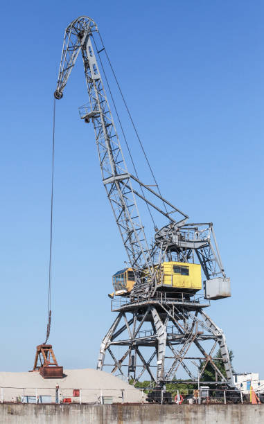 istock Portal crane works on the river coast 2185056555