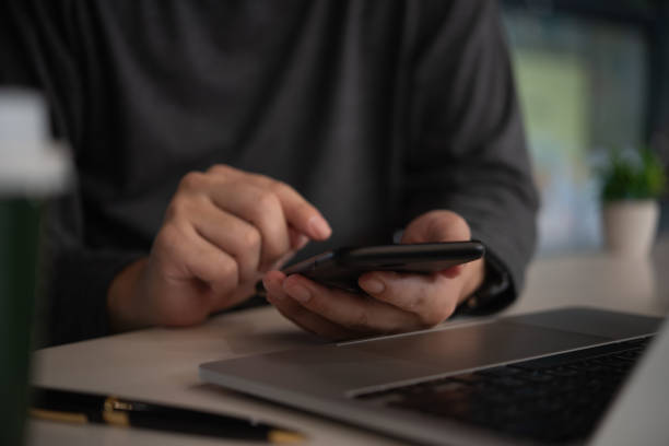 istock Business man using mobile smart phone management information financial documents, marketing online, job and payment digital technology on desk. 2185057764