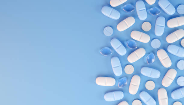 istock 3d rendering of some blue and white tablets, pills. 2185058277