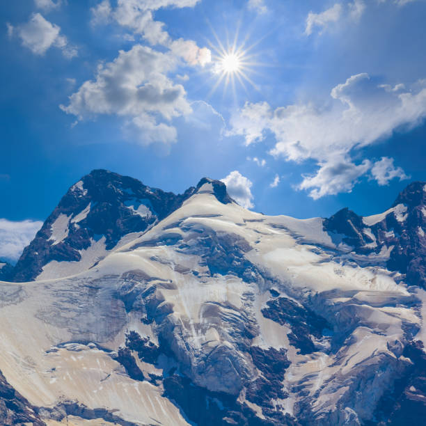 Triumphant and exhilarated, an alpinist stands proudly on the summit of a majestic mountain in the Swiss Alps, having conquered nature's heights with unwavering determination and skill.