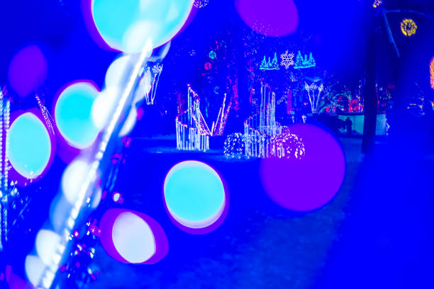 Blurred Christmas wreath, a door with a Christmas wreath with lights defocused, object purposely out of focus.