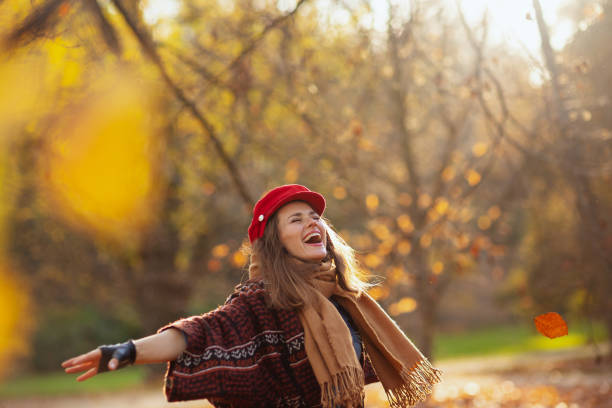 istock smiling elegant woman in red hat with scarf rejoicing 2185064397
