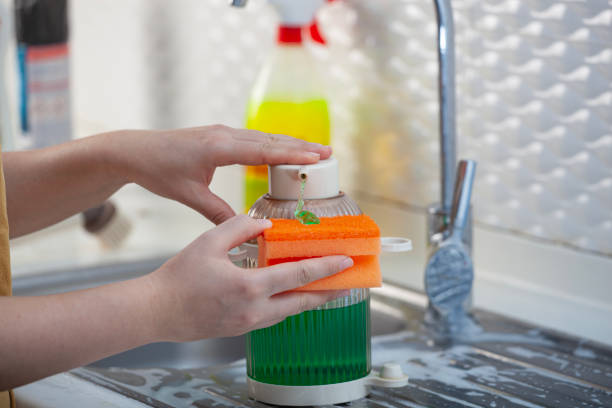 istock Woman putting detergent to sponge 2185064664