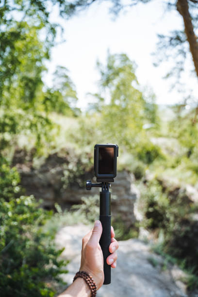 istock In a serene natural environment, a hand gripping a camera represents exploration and adventure in the wilderness with the aid of technology for capturing the beauty of nature 2185068782