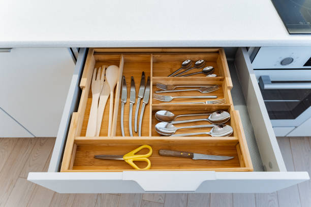 istock The kitchen drawer is neatly organized with different utensils and scissors, displaying a mix of Wood, Metal, and Rectangular shapes, creating a harmonious combination of materials 2185068850