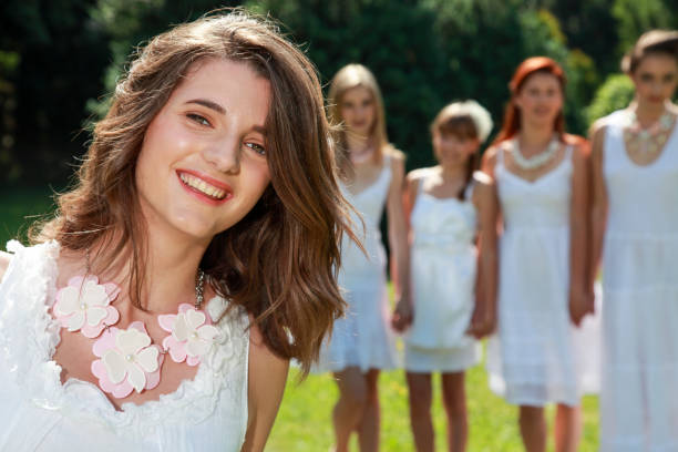 Five female friends in white dresses enjoying nature. Portrait of one photo. Wedding female group.