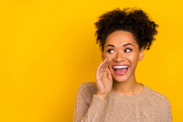 istock Photo of charming funky lady dressed beige pullover making announcement empty space isolated yellow color background 2185072425