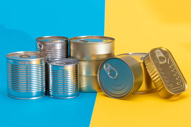 istock A Group of Stacked Tin Cans on Split Blue and Yellow Background 2185072673