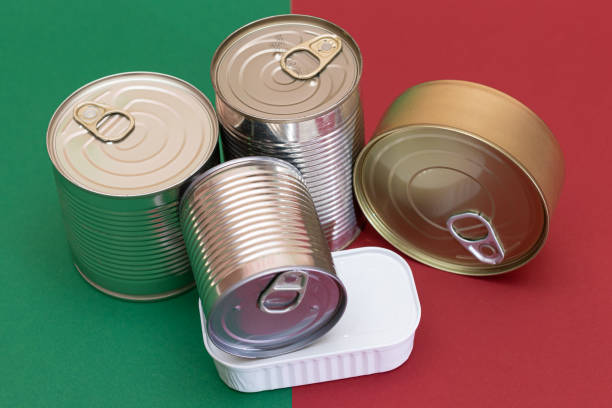 istock A Group of Stacked Tin Cans on Split Red and Green Background 2185072693